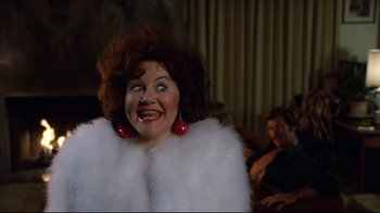 Movie still from “Eating Raoul” (1982), directed by Paul Bartel – A person wearing a fur coat; Close Up shot, Low angle