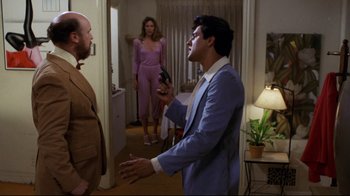 Movie still from “Eating Raoul” (1982), directed by Paul Bartel – Two men and a woman standing in front of a door; Medium shot, Over the shoulder angle