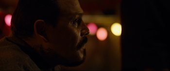 Movie still from “El Chicano” (2018), directed by Ben Hernandez Bray – A man's face with lights in the background; Close Up shot, Over the shoulder angle
