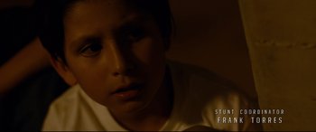 Movie still from “El Chicano” (2018), directed by Ben Hernandez Bray – A young boy is sitting in a dark room; Close Up shot, High angle