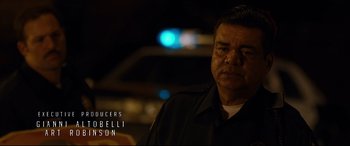 Movie still from “El Chicano” (2018), directed by Ben Hernandez Bray – A person wearing a black shirt; Close Up shot, Over the shoulder angle
