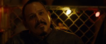 Movie still from “El Chicano” (2018), directed by Ben Hernandez Bray – A person with a beard and mustache; Close Up shot, Over the shoulder angle