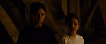 Movie still from “El Chicano” (2018), directed by Ben Hernandez Bray – Two young boys standing next to each other in the dark; Close Up shot, High angle