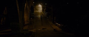 Movie still from “El Chicano” (2018), directed by Ben Hernandez Bray – A person laying on the ground in the dark; Extreme Wide shot, High angle