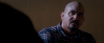 Movie still from “El Chicano” (2018), directed by Ben Hernandez Bray – A bald man with blood all over his face; Close Up shot, Over the shoulder angle