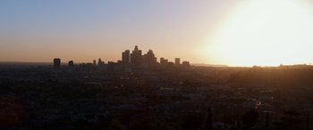 Movie still from “El Chicano” (2018), directed by Ben Hernandez Bray – The sun is setting over a large city; Extreme Wide shot, High angle