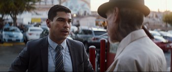 Movie still from “El Chicano” (2018), directed by Ben Hernandez Bray – A man talking to another man on the street; Medium shot, Over the shoulder angle