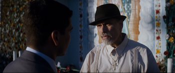 Movie still from “El Chicano” (2018), directed by Ben Hernandez Bray – A man wearing a hat talking to another man; Close Up shot, Over the shoulder angle