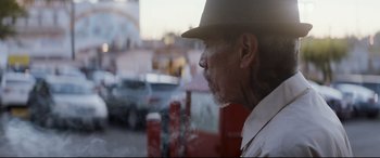 Movie still from “El Chicano” (2018), directed by Ben Hernandez Bray – An older man wearing a hat looking out of a window; Close Up shot, Low angle