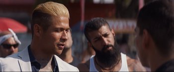 Movie still from “El Chicano” (2018), directed by Ben Hernandez Bray – A man with blonde hair standing next to a man with a beard; Close Up shot, Over the shoulder angle