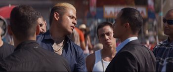 Movie still from “El Chicano” (2018), directed by Ben Hernandez Bray – Two men and a woman talking to each other on the street; Close Up shot, Over the shoulder angle