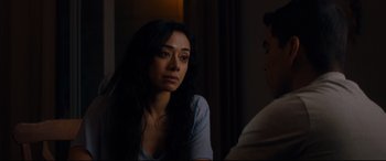 Movie still from “El Chicano” (2018), directed by Ben Hernandez Bray – A woman sitting in front of a man in front of a window; Close Up shot, Over the shoulder angle