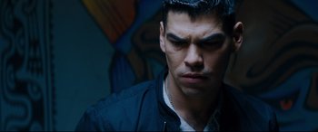 Movie still from “El Chicano” (2018), directed by Ben Hernandez Bray – A person wearing a black jacket; Close Up shot, High angle