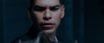 Movie still from “El Chicano” (2018), directed by Ben Hernandez Bray – A man's face in a dark room; Close Up shot, Over the shoulder angle