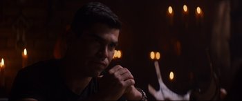 Movie still from “El Chicano” (2018), directed by Ben Hernandez Bray – A young man is sitting in a dark room; Close Up shot, Over the shoulder angle