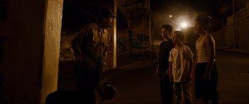 Movie still from “El Chicano” (2018), directed by Ben Hernandez Bray – A group of young men standing next to each other on a street; Wide shot, Over the shoulder angle