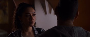 Movie still from “El Chicano” (2018), directed by Ben Hernandez Bray – A woman is looking at a man in a room; Close Up shot, Over the shoulder angle