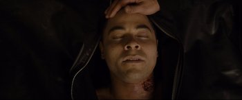 Movie still from “El Chicano” (2018), directed by Ben Hernandez Bray – A man is laying on the ground with his head in his hands; Close Up shot, Overhead angle