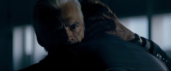 Movie still from “El Chicano” (2018), directed by Ben Hernandez Bray – An older man with white hair is hugging a couch; Close Up shot, Over the shoulder angle
