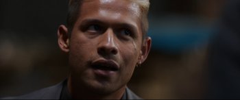 Movie still from “El Chicano” (2018), directed by Ben Hernandez Bray – A person with blond hair; Close Up shot, Over the shoulder angle