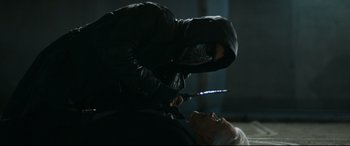 Movie still from “El Chicano” (2018), directed by Ben Hernandez Bray – A person with a knife in their hand is cutting a woman's face; Close Up shot, Over the shoulder angle