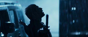 Movie still from “El Chicano” (2018), directed by Ben Hernandez Bray – A man holding a sword in the rain; Close Up shot, Low angle