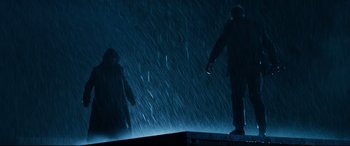 Movie still from “El Chicano” (2018), directed by Ben Hernandez Bray – A man and a woman standing in the rain; Wide shot, Low angle