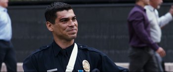 Movie still from “El Chicano” (2018), directed by Ben Hernandez Bray – A man in a police uniform is looking to his left; Close Up shot, Over the shoulder angle