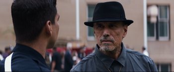 Movie still from “El Chicano” (2018), directed by Ben Hernandez Bray – An older man wearing a black hat talking to a younger man; Close Up shot, Over the shoulder angle