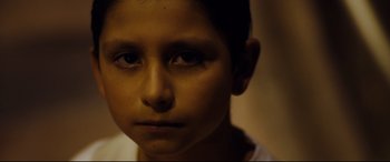 Movie still from “El Chicano” (2018), directed by Ben Hernandez Bray – A young boy's face in the dark; Close Up shot, High angle
