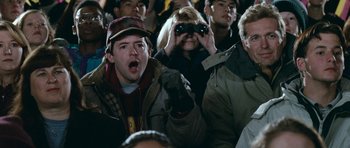 Movie still from “Election” (1999), directed by Alexander Payne – A group of people sitting in a stadium watching a game; Medium shot, High angle