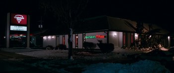 Movie still from “Election” (1999), directed by Alexander Payne – A building with a tree in front of it at night time; Extreme Wide shot, High angle