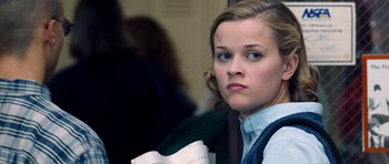 Movie still from “Election” (1999), directed by Alexander Payne – A person holding a book; Close Up shot, Low angle