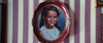 Movie still from “Election” (1999), directed by Alexander Payne – A picture of a young girl in an ornate frame; Extreme Close Up shot, Overhead angle