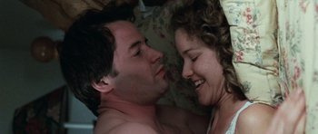 Movie still from “Election” (1999), directed by Alexander Payne – A man and a woman laying in bed together; Close Up shot, Overhead angle