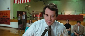 Movie still from “Election” (1999), directed by Alexander Payne – A man in a tie is holding a microphone; Close Up shot, Low angle