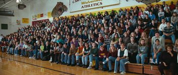 Movie still from “Election” (1999), directed by Alexander Payne – A large group of people sitting in front of an audience; Wide shot, High angle