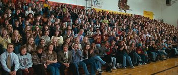 Movie still from “Election” (1999), directed by Alexander Payne – A large group of people sitting in the bleachers; Wide shot, High angle