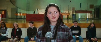 Movie still from “Election” (1999), directed by Alexander Payne – A young woman is speaking into a microphone; Close Up shot, Over the shoulder angle