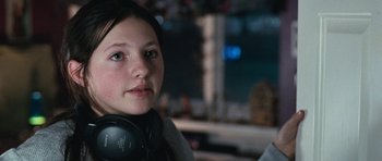 Movie still from “Election” (1999), directed by Alexander Payne – A young girl wearing headphones and looking into the distance; Close Up shot, Over the shoulder angle
