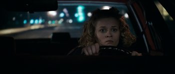 Movie still from “Election” (1999), directed by Alexander Payne – A woman sitting in the driver's seat of a car at night; Close Up shot, Over the shoulder angle