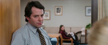 Movie still from “Election” (1999), directed by Alexander Payne – A man and woman sitting in a living room next to each other; Close Up shot, Over the shoulder angle