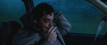 Movie still from “Election” (1999), directed by Alexander Payne – A man sitting in a car with his hand to his face; Close Up shot, High angle