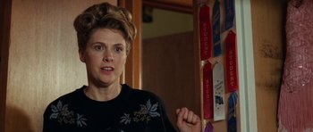 Movie still from “Election” (1999), directed by Alexander Payne – A woman standing in front of a wall of ribbons; Close Up shot, Over the shoulder angle