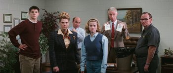 Movie still from “Election” (1999), directed by Alexander Payne – A group of people standing in front of a wall; Medium shot, Low angle