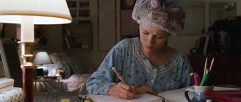 Movie still from “Election” (1999), directed by Alexander Payne – A woman wearing a hair net writing in a notebook; Close Up shot, High angle