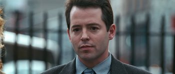 Movie still from “Election” (1999), directed by Alexander Payne – A person wearing a suit and tie; Close Up shot, Over the shoulder angle