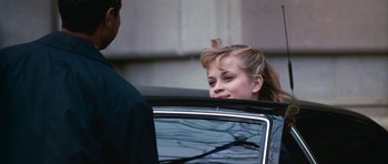 Movie still from “Election” (1999), directed by Alexander Payne – A young girl sitting in the back seat of a car; Close Up shot, Over the shoulder angle