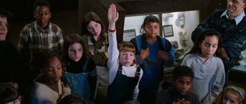 Movie still from “Election” (1999), directed by Alexander Payne – A group of kids standing in front of a wall; Medium shot, High angle
