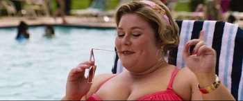 Movie still from “Dumplin'” (2018), directed by Anne Fletcher – A woman in a pink top is holding a glass; Close Up shot, Low angle